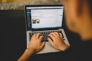 a man typing on his laptop